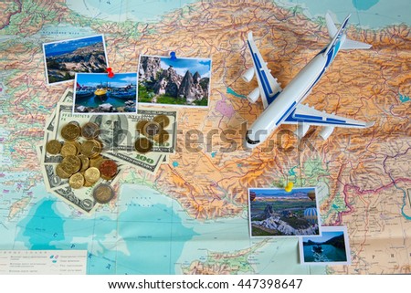 Travel concept plan and prepare for the journey to Turkey. Money, plane and pictures on the map with the background of the Russian language.