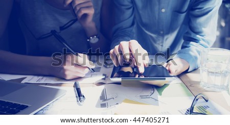 Photo Woman Hand Touching Digital Tablet Screen.Analyst Department Researching Process.Young Business Crew Working New Startup modern Studio.Analyze markets stocks.Blurred,film effect.Wide