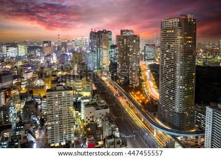 Dense buildings in Minato-ku, Tokyo Japan with Tokyo Sky tree visible on the horizon.
