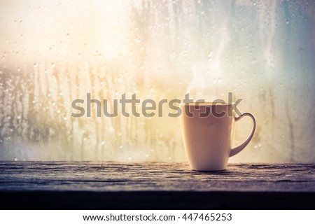 Coffee cup on a rainy day window background