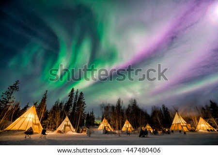 A wonderful night with Kp 5 index northern lights at Aurora Village in Yellowknife. Royalty-Free Stock Photo #447480406