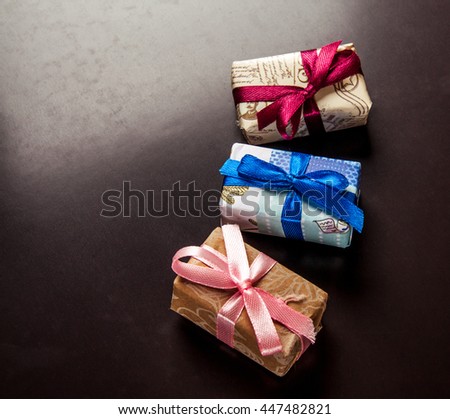 Gifts basket and candle against black background
