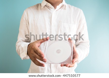 Asian man holding DVD-ROM