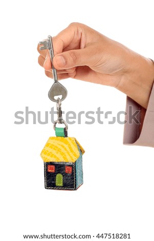 Business woman holding house key against white background