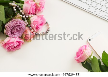 Styled flat desktop frame scene with mobile and flowers, copy space on white table
