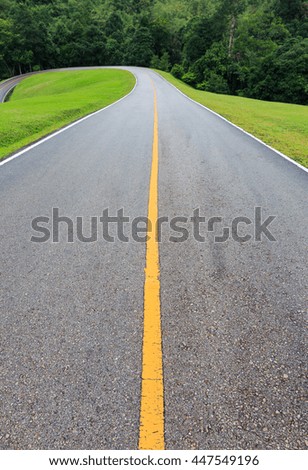 Road with green grass on either side.