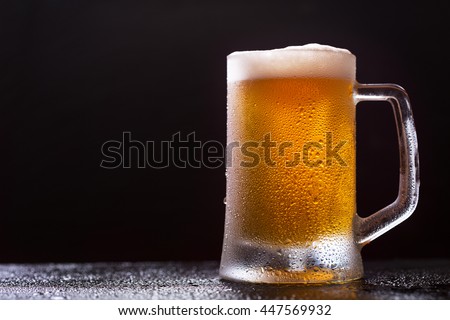 mug of beer on dark background Royalty-Free Stock Photo #447569932