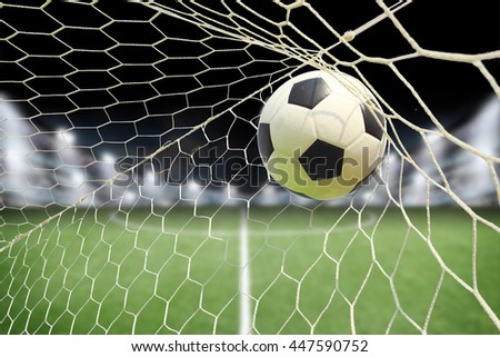 soccer ball in goal with spotlight Royalty-Free Stock Photo #447590752