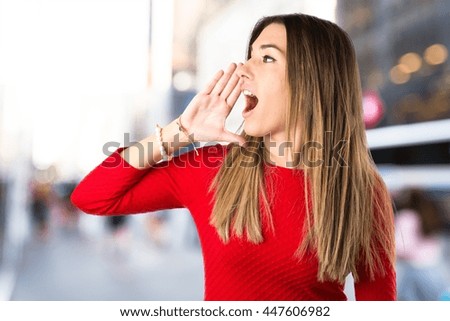 Young girl shouting on unfocused background