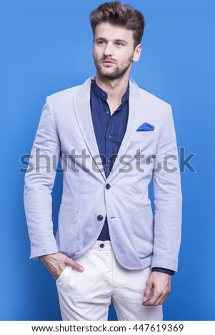 Handsome man in a dark blue shirt on a blue background