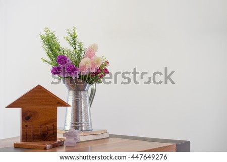 Welcome wood table with flower pot and house icon over white background