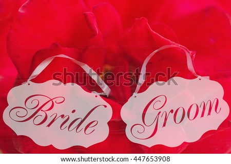 Double exposure with bride and groom decoration boards and blooming flowers