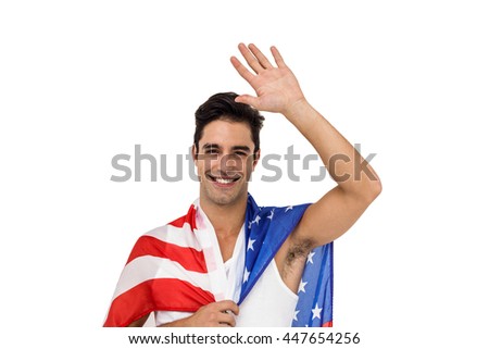 Male athlete posing with american flag wrapped around his body on white background