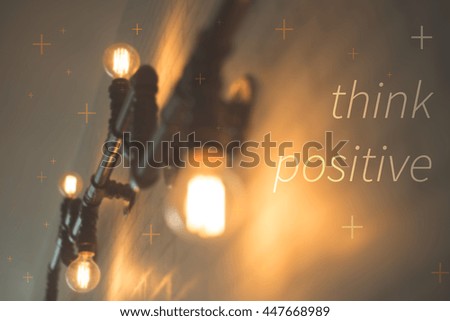 Think positive concept. Light bulb decoration on wall background.