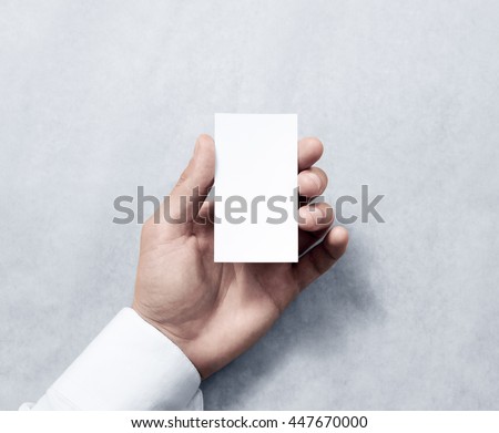 Hand holding blank vertical white business card design mockup. Clear calling card mock up template hold arm. Visiting pasteboard paper surface display front. Small pure offset card holder presentation