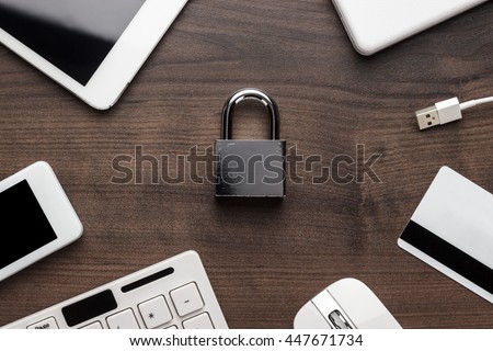 padlock and different gadgets on the wooden office table. privacy protection, encrypted connection concept, buying online Royalty-Free Stock Photo #447671734