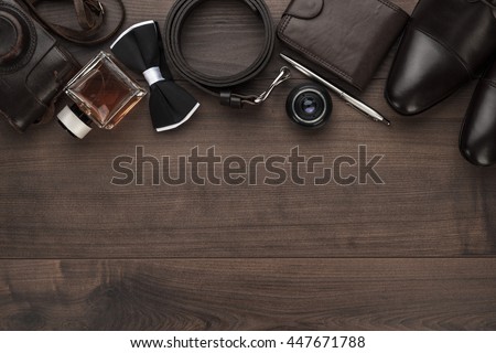 men's accessories in order on the brown wooden table overhead view with copy space Royalty-Free Stock Photo #447671788