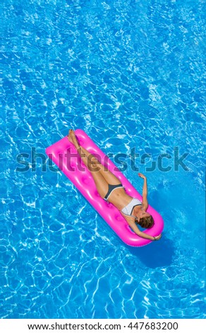 Beautiful young woman in bikini Relaxing in a swimming pool
