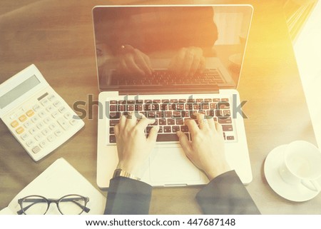 business woman use online laptop computer for analyzing financial chart,writing business plan,open net-book,phone,tablets,with copy space screen,selective focus,vintage color