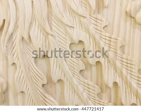 Pattern of flower and leaf carved on wood background