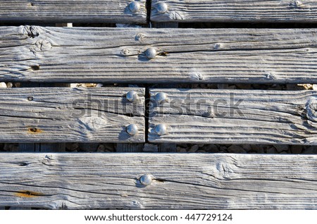 Gray hardwood planks with nails. Wooden striped fiber textured background. High quality high resolution plywood background. Close up brown grainy surface wood texture of parquet or part of furniture.