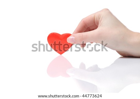 Small valentine heart in a female hand isolated on white background
