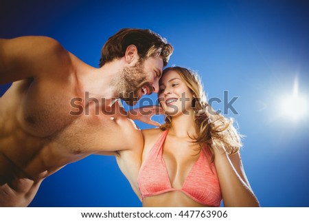 Romantic young couple against sky on a sunny day