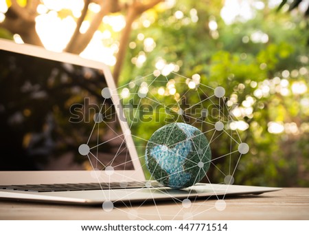 mock up the globe  with digital social media network on keyboard laptop computer in nature background