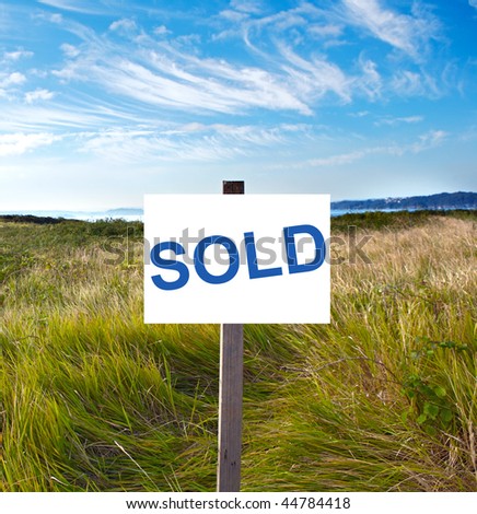 Blank billboard with message "sold" in the field