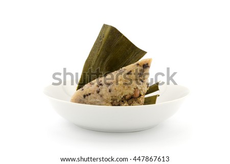 Traditional wrapped rice dumplings or zongzi on a plate, isolated on white background