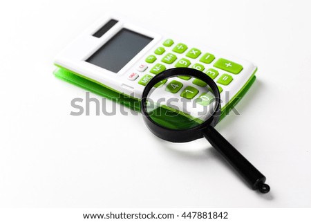 Calculator with a magnifying glass on a white background