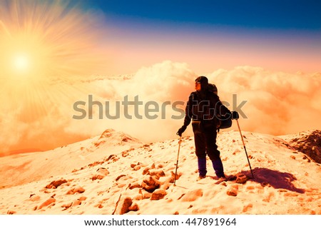Beautiful amazing sunset winter mountains. A man goes a sport hike in snow holidays. Nature background. Unique landscape. Northern country Russia Caucasus. Sunny rays. New year. Quest