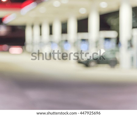 Blurred of gas station at night. Defocused, out of focus gas station and convenience store in evening. Abstract blur petrol station background with copy space.