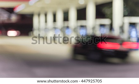 Blurred of gas station at night. Defocused, out of focus gas station and convenience store in evening. Abstract blur petrol station background with copy space. Panorama style.