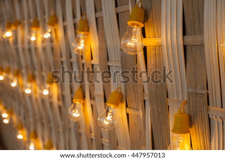 Lamps hanging on the walls of bamboo.