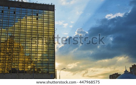 modern skyscrapers in business district in evening light at Sunset Sunbeams. Toned Instant Photo with lens flare filter effect