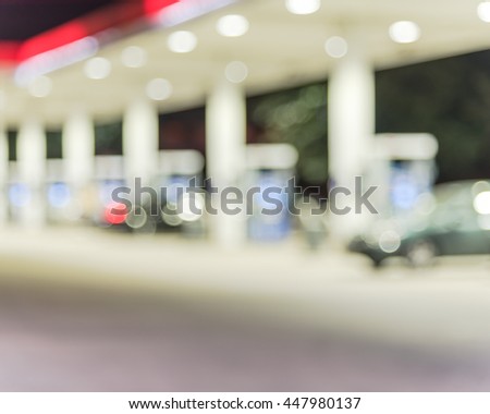 Blurred of gas station at night. Defocused, out of focus gas station and convenience store in evening. Abstract blur petrol station background with copy space.