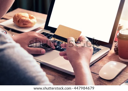 Man hands using smartphone laptop and holding credit card with social media as Online shopping concept in morning light.vintage effect