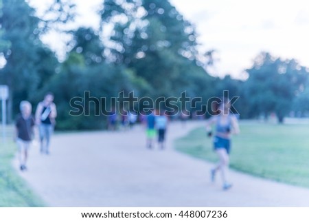 Defocused, blurred motion background of summer activities with energetic people jogging, walking, running and bicycling at green city park. Urban outdoor workout.Healthy lifestyle concept.Vintage look