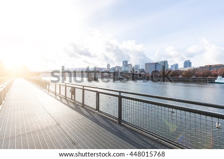 cityscape and skyline of portland in cloud sky on view from empty pedestrian bridge