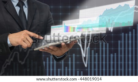 Businessman using the tablet shown the trading graph of stock market on the virtual screen over the stock chart background, Business stock market concept