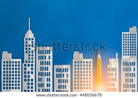 Paper-cut style city  with wooden pencil on blue leather background
