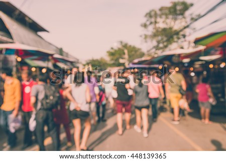Abstract blur tourist shopping in Chatuchak weekend market outdoor in sunny day Bangkok Thailand background - Vintage filter effect