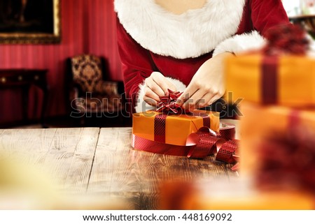 woman in red clothes of santa claus and gifts 