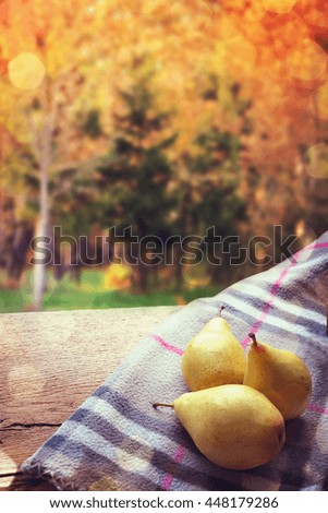  Pears on the table in the autumn park.