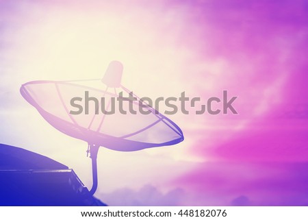 satellite dish and TV antennas on the house roof with sunset sky background