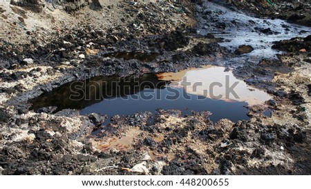 Effects nature from soil contaminated with chemicals and oil. Environmental disaster, contamination of the environment, toxic, pollution, detail. Dump toxic waste. Royalty-Free Stock Photo #448200655