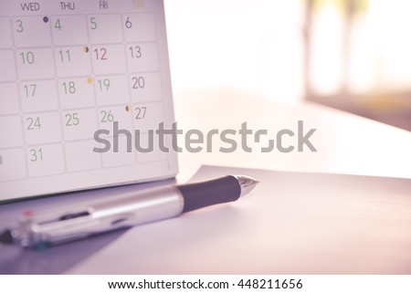 blurred calendar with pen in planning concept.pink tone
