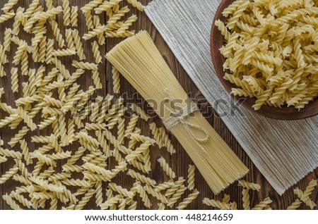Pasta on wooden background in the plate - vintage effect style pictures