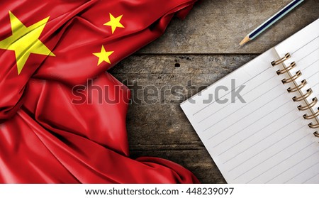 China flag and notebook on wooden table, high contrast and over light [3D illustration]